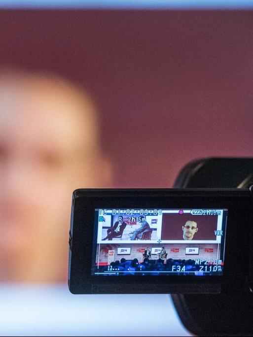 Der US-amerikanischer Whistleblower Edward Snowden ist während einer Videoliveschalte auf einem Monitor zu sehen.