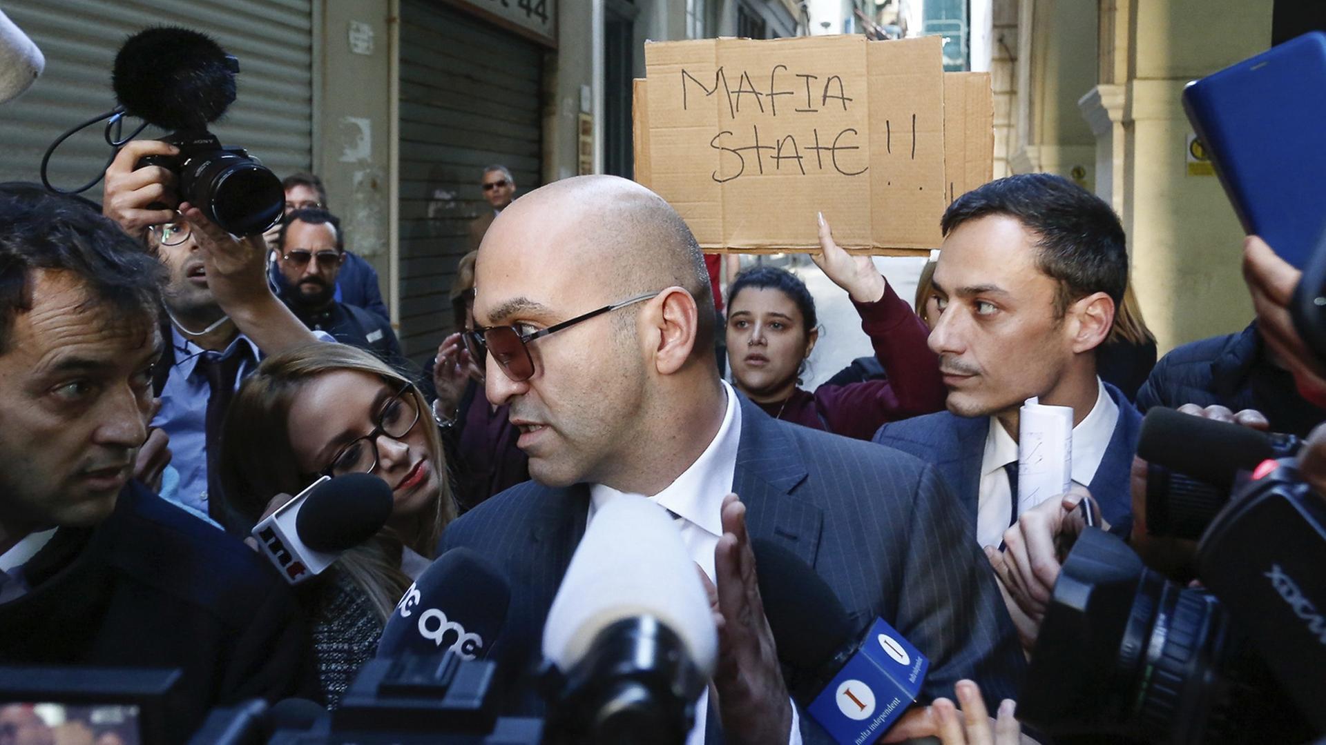 Maltese businessman Yorgen Fenech, who was taken into custody by police last week as he was trying to flee the island, receives media attention as he leaves court after being questioned in the 2017 bomb blast that killed investigative journalist Daphne Caruana Galizia as she drove near her home, in Valletta, Malta, Friday, Nov. 29. 2019. (AP Photo/str) Maltese businessman Yorgen Fenech, who was taken into custody by police last week as he was trying to flee the island, receives media attention as he leaves court after being questioned in the 2017 bomb blast that killed investigative journalist Daphne Caruana Galizia as she drove near her home, in Valletta, Malta, Friday, Nov. 29. 2019. (AP Photo/str)