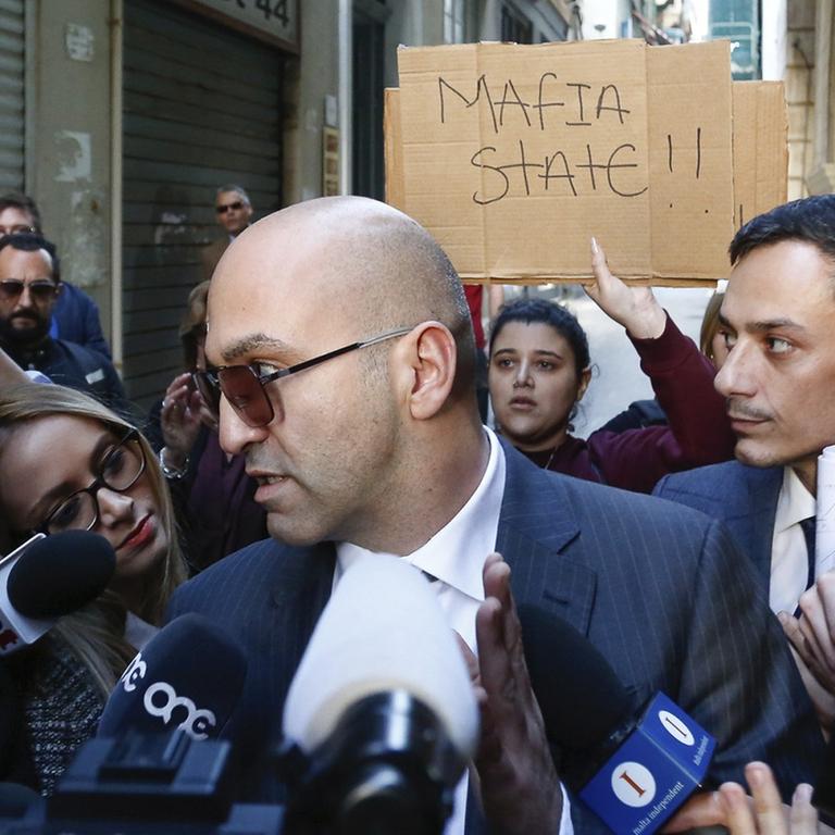 Maltese businessman Yorgen Fenech, who was taken into custody by police last week as he was trying to flee the island, receives media attention as he leaves court after being questioned in the 2017 bomb blast that killed investigative journalist Daphne Caruana Galizia as she drove near her home, in Valletta, Malta, Friday, Nov. 29. 2019. (AP Photo/str)