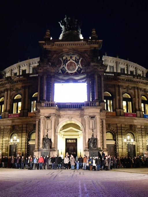 Eine Menschenkette zieht sich in Dresden über den Theaterplatz vor der Semperoper, um der Zerstörung der Stadt im Zweiten Weltkrieg zu gedenken.