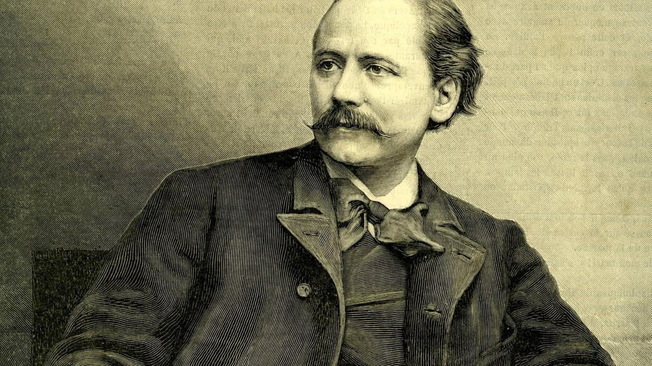 Historisches Porträt des Komponisten, der locker in einem Lehnstuhl sitzt. 