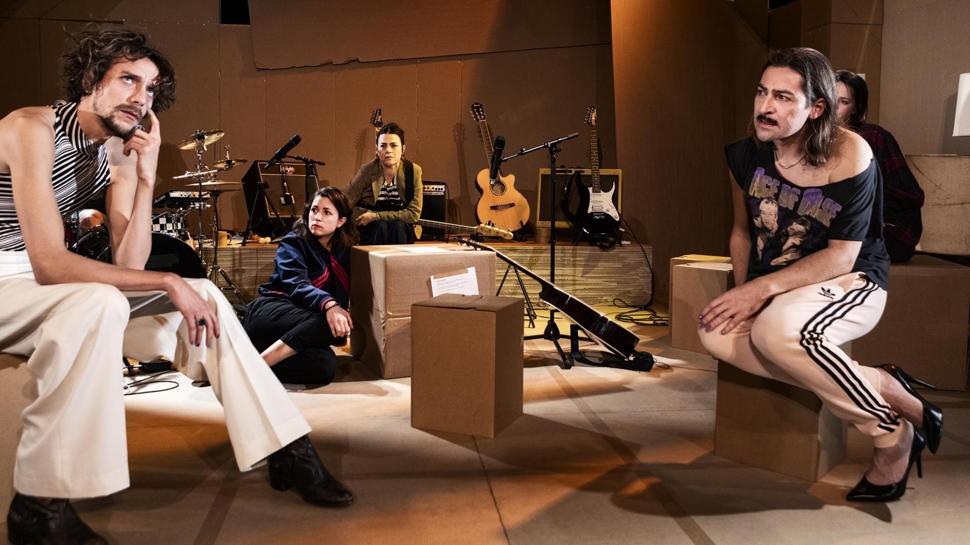 Das Schauspielerensemble sitzt auf einer Probenraum ähnlichen Bühne auf Boxen zwischen Instrumenten in dem Stück ‘HE? SHE? ME! FREE’, einem Projekt von Patrick Wengenroth an der Schaubuehne am Lehniner Platz Das Schauspielerensemble sitzt auf einer Probenraum ähnlichen Bühne auf Boxen zwischen Instrumenten in dem Stück ‘HE? SHE? ME! FREE’, einem Projekt von Patrick Wengenroth an der Schaubuehne am Lehniner Platz