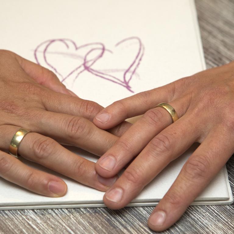 Zwei Frauen tragen Ringe als Zeichen Ihrer eingetragenen Lebenspartnerschaft. 