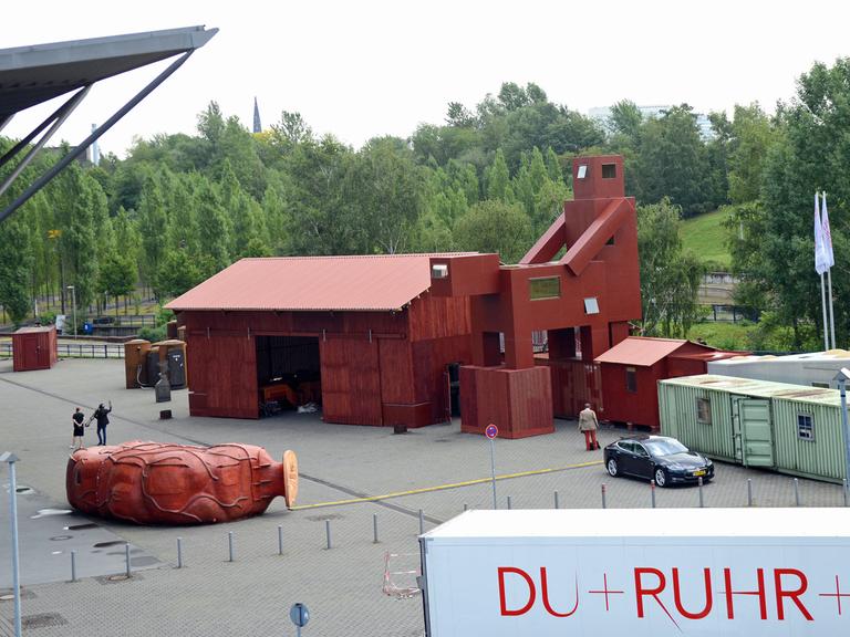 Neben der Jahrhunderthalle in Bochum stehen am 7.8.2015 für die Ruhrtriennale 2015 schon erste Teile der Installation "The Good, the Bad and the Ugly", die vom Atelier Van Lieshout aus den Niederlanden realisiert wurde.