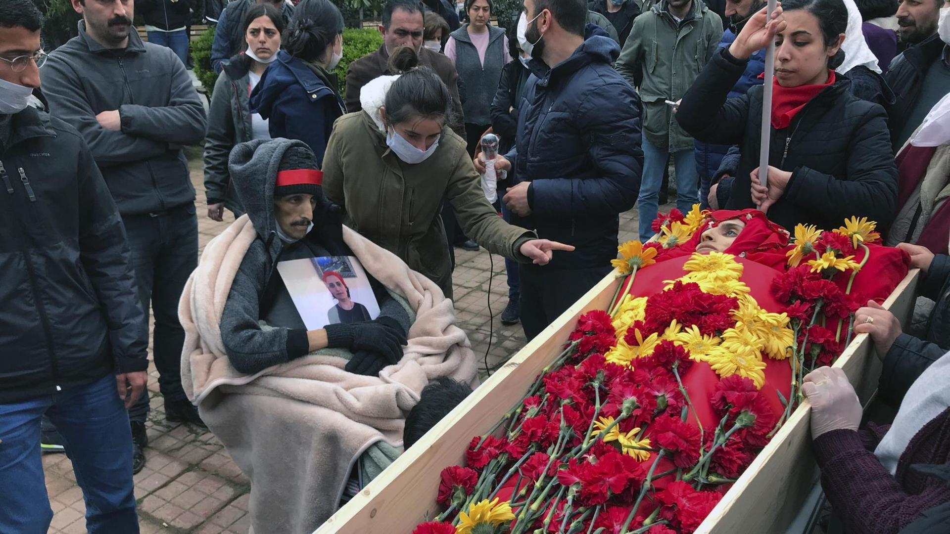 Trauernde Menschen am offenen Sarg der türkischen Sängerin Helin Bölek der Grup Yorum.