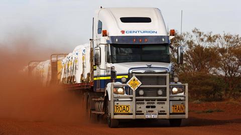 Ein Truck fährt über eine staubige Straße in Australien.
