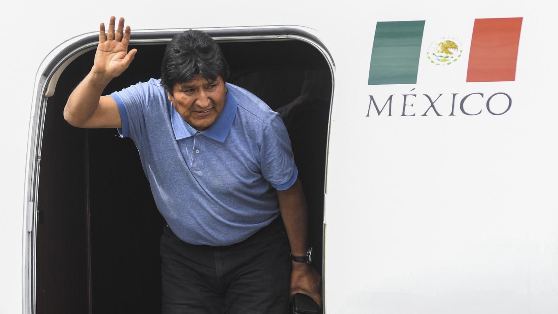Boliviens Ex-Präsident Morales steigt nach seiner Landung in Mexiko City aus einem Flugzeug und winkt.
