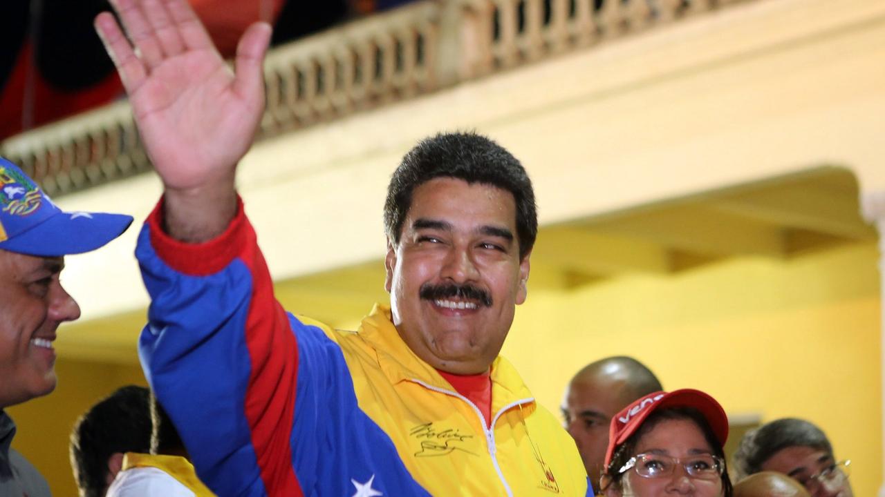 Der venezolanische Präsident Nicolas Maduro winkt am 13. Februar 2015 seinen Anhängern zu. Er trägt eine Jacke in den Nationalfarben Venezuelas.