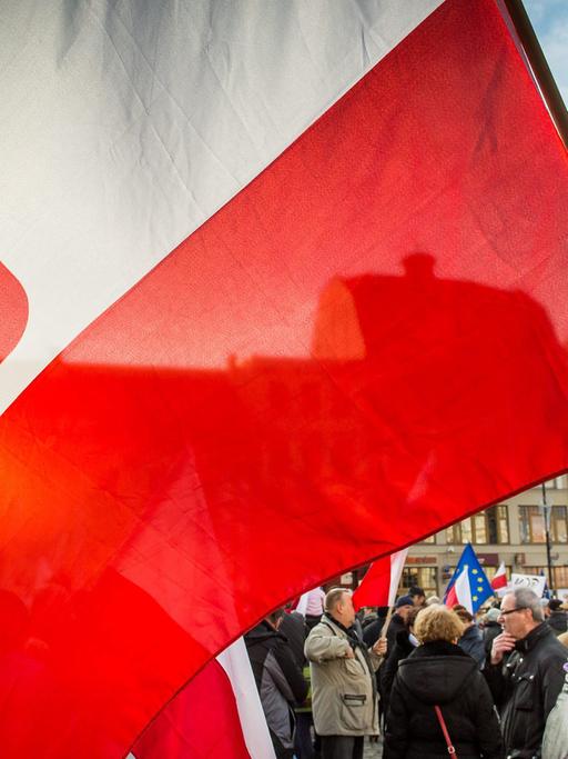 Menschen in Bydgoszcz demonstrieren mit polnischer Flagge gegen die PiS-Regierung.
