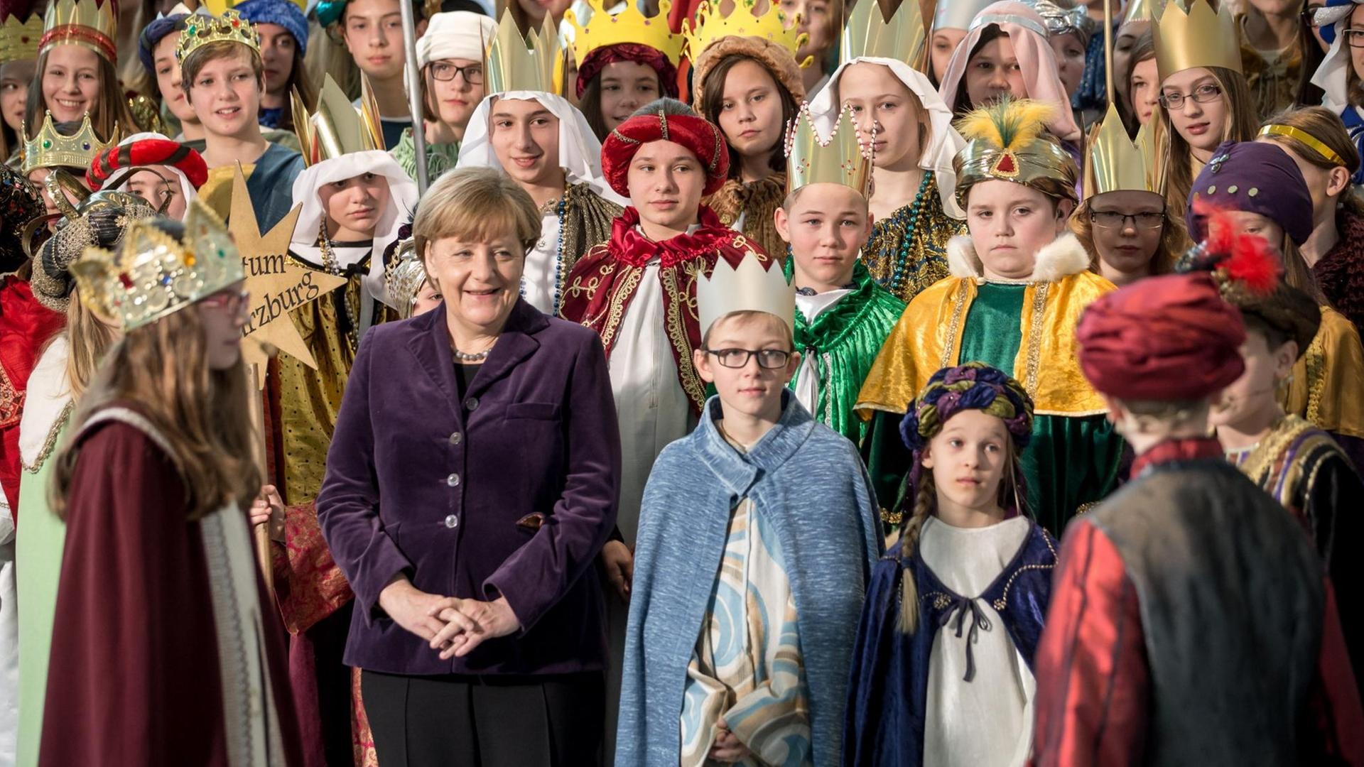 Stern-Singer stehen auf einer Treppe, in der Mitte steht die Bundes-Kanzlerin Stern-Singer stehen auf einer Treppe, in der Mitte steht die Bundes-Kanzlerin