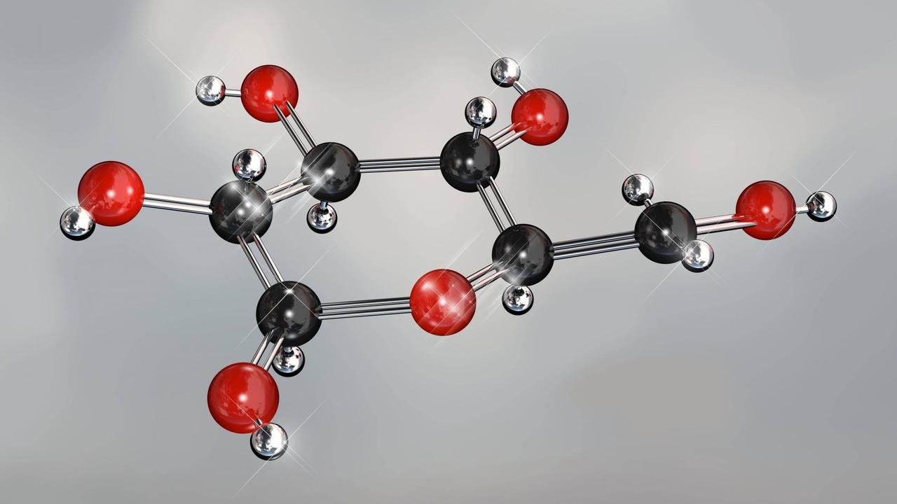 Ein Modell eines Glucose-Moleküls: schwarze und rote Kugeln an einem silbernen Gestänge
