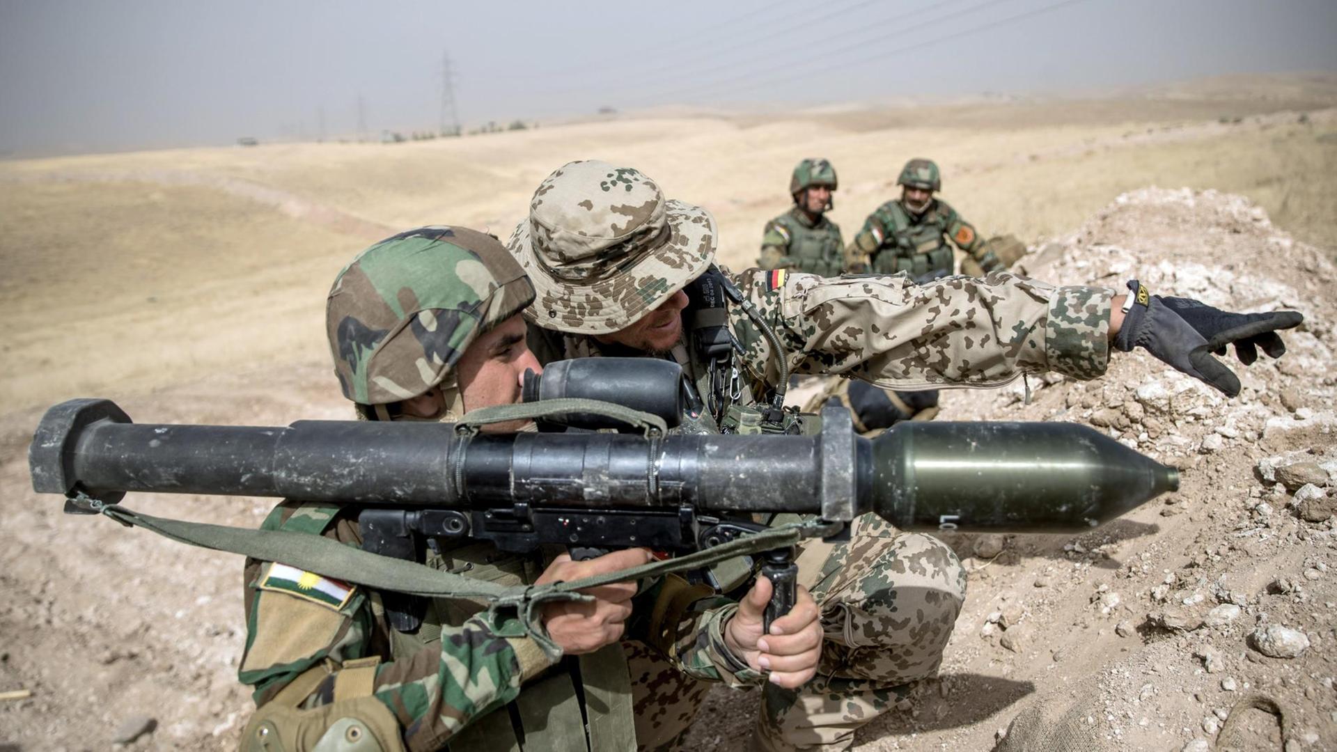 Ein Soldat der Bundeswehr weist einen Angehörigen der Peschmerga in einer Ausbildungseinrichtung bei einer Übung ein. Ein Soldat der Bundeswehr weist einen Angehörigen der Peschmerga in einer Ausbildungseinrichtung bei einer Übung ein.