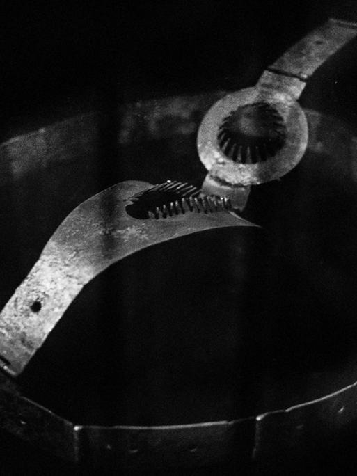 Ein Keuschheitsgürtel, fotografiert vor schwarzem Hintergrund
