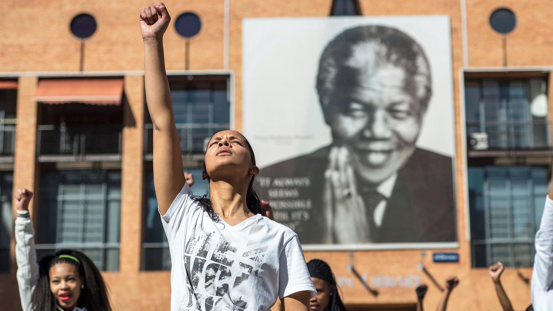 Die Zukunft Südafrikas: Junge Menschen vor einem Nelson Mandela Portrait in Johannesburg