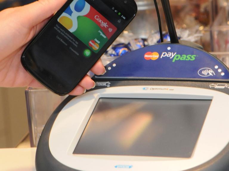 Ein Google-Smartphone wird an einer Supermarkt-Kasse neben ein so genanntes PayPass Gerät zur elektronischen Zahlungsabwicklung gehalten (undatiertes Google-Handout). Statt des dicken Portemonnaies soll bald nur noch ein schlankes Smartphone ausreichen.