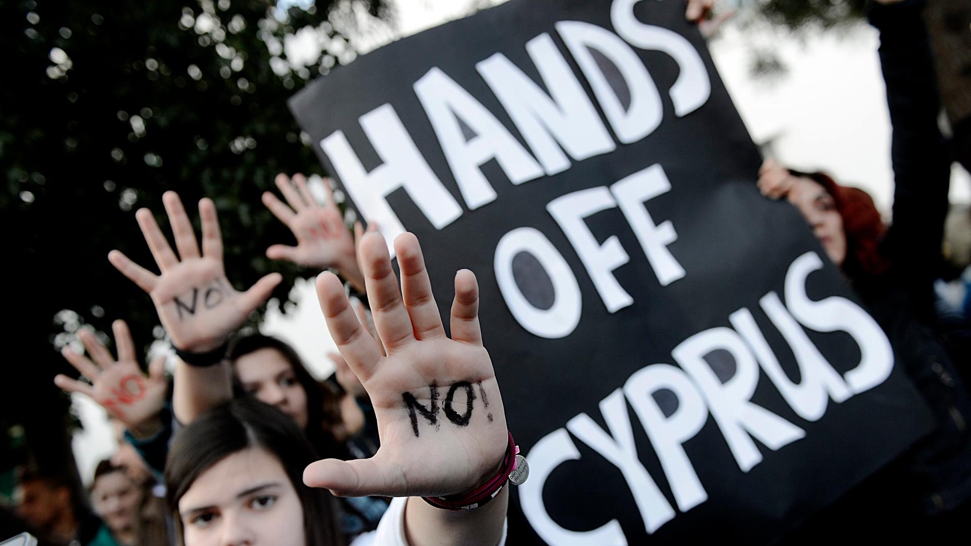 epa03630434 A protester is seen during the rally against the ratification of a one-off tax in front of the Cyprus parliament in Nicosia, Cyprus, 18 March 2013. The Cyprus parliament has been postponed until 19 March on ratification of a one-off tax on ban epa03630434 A protester is seen during the rally against the ratification of a one-off tax in front of the Cyprus parliament in Nicosia, Cyprus, 18 March 2013. The Cyprus parliament has been postponed until 19 March on ratification of a one-off tax on ban