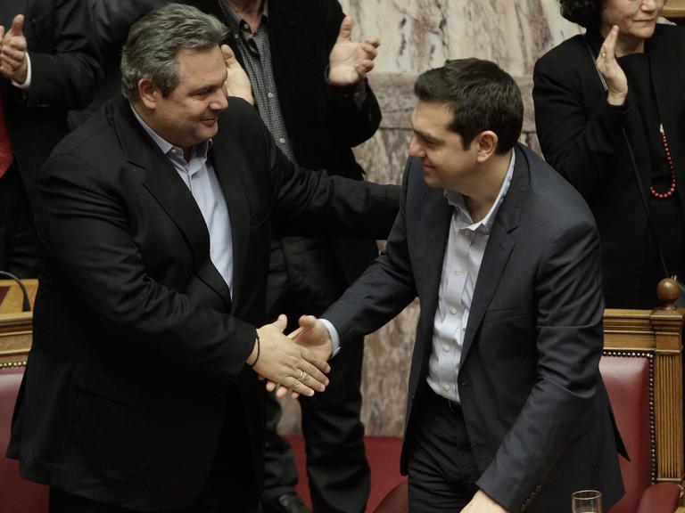 Panos Kammenos schüttelt Alexis Tsipras die Hand.