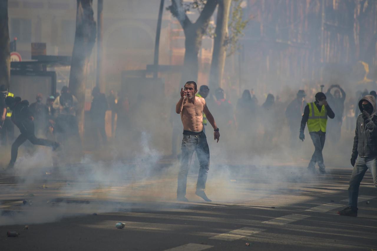 Anhänger der Gelbwesten-Bewegung stehen bei den Protesten in Toulouse in einem Nebel aus Tränengas.