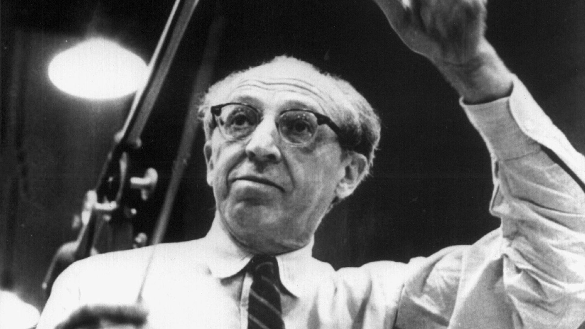 Der US-amerikanische Komponist und Dirigent am Dirigentenpult (undatiert). Aaron Copland wurde am 14. November 1900 in Brooklyn geboren und ist am 2. Dezember 1990 in New York gestorben.