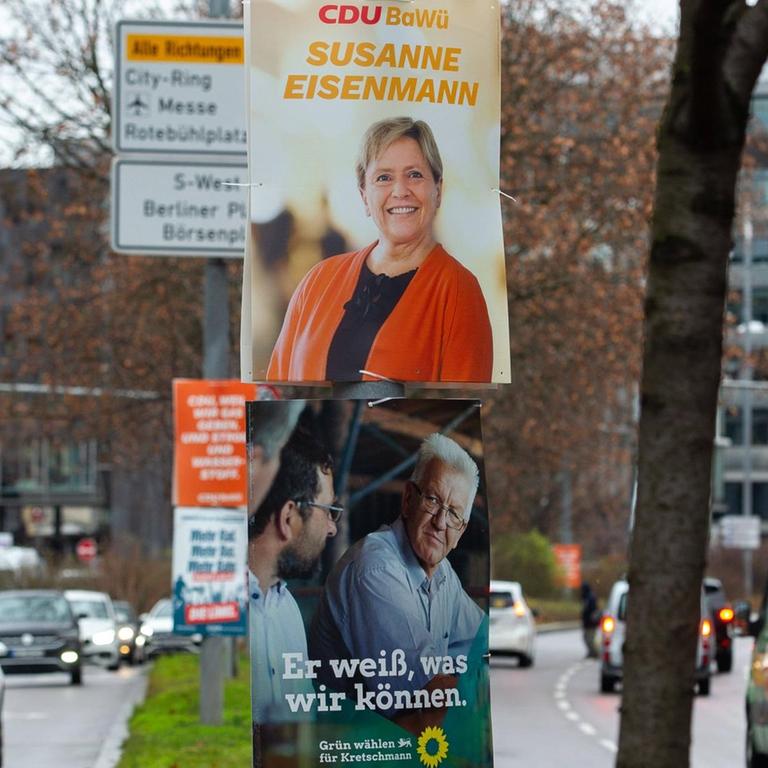 Auf Wahlplakaten in Stuttgart sind die Spitzenkandidatin der CDU, Susanne Eisenmann, und der Spitzenkandidat der Grünen, Winfried Kretschmann, zu sehen.