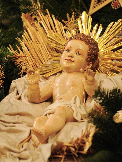 Eine geschnitzte Christkindfigur.