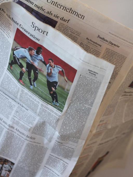 Ein Teilnehmer liest am 06.06.2013 in Köln (Nordrhein-Westfalen) auf dem Medienforum in Köln eine Tageszeitung.