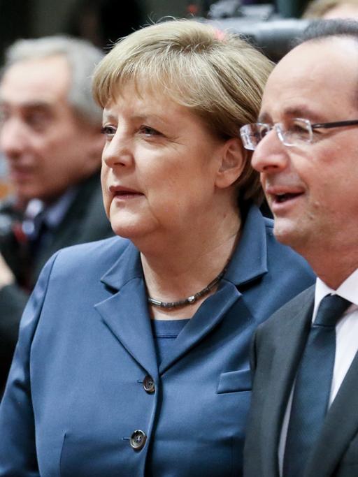 Bundeskanzlerin Angela Merkel und Frankreichs Präsident Francois Hollande unterhalten sich auf dem EU-Gipfel in Brüssel.
