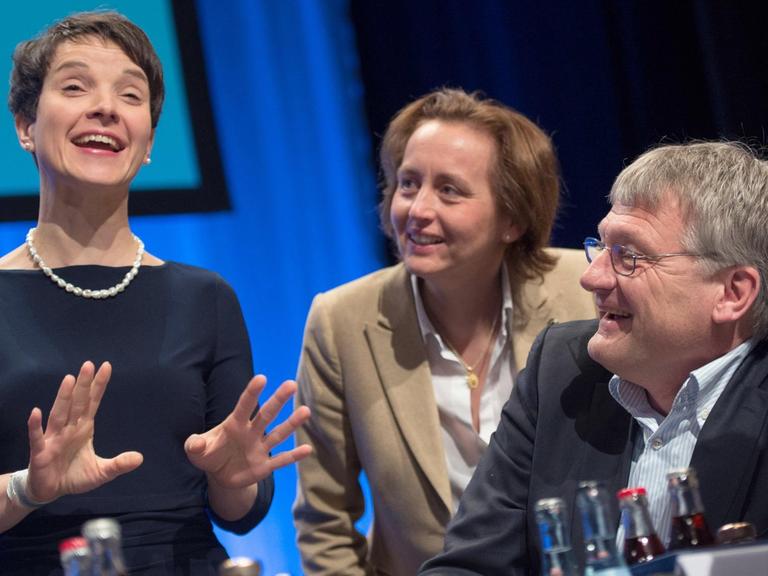 Frauke Petry, Beatrix von Storch und Jörg Meuthen unterhalten sich auf dem AfD-Parteitag, alle drei lächeln.