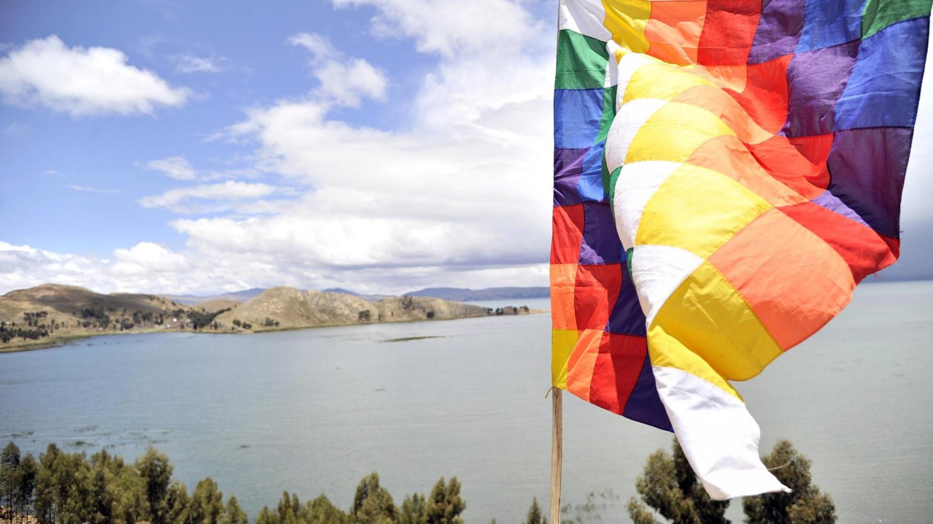 Der Titicacasee und im Vordergrund eine bunte Fahne.