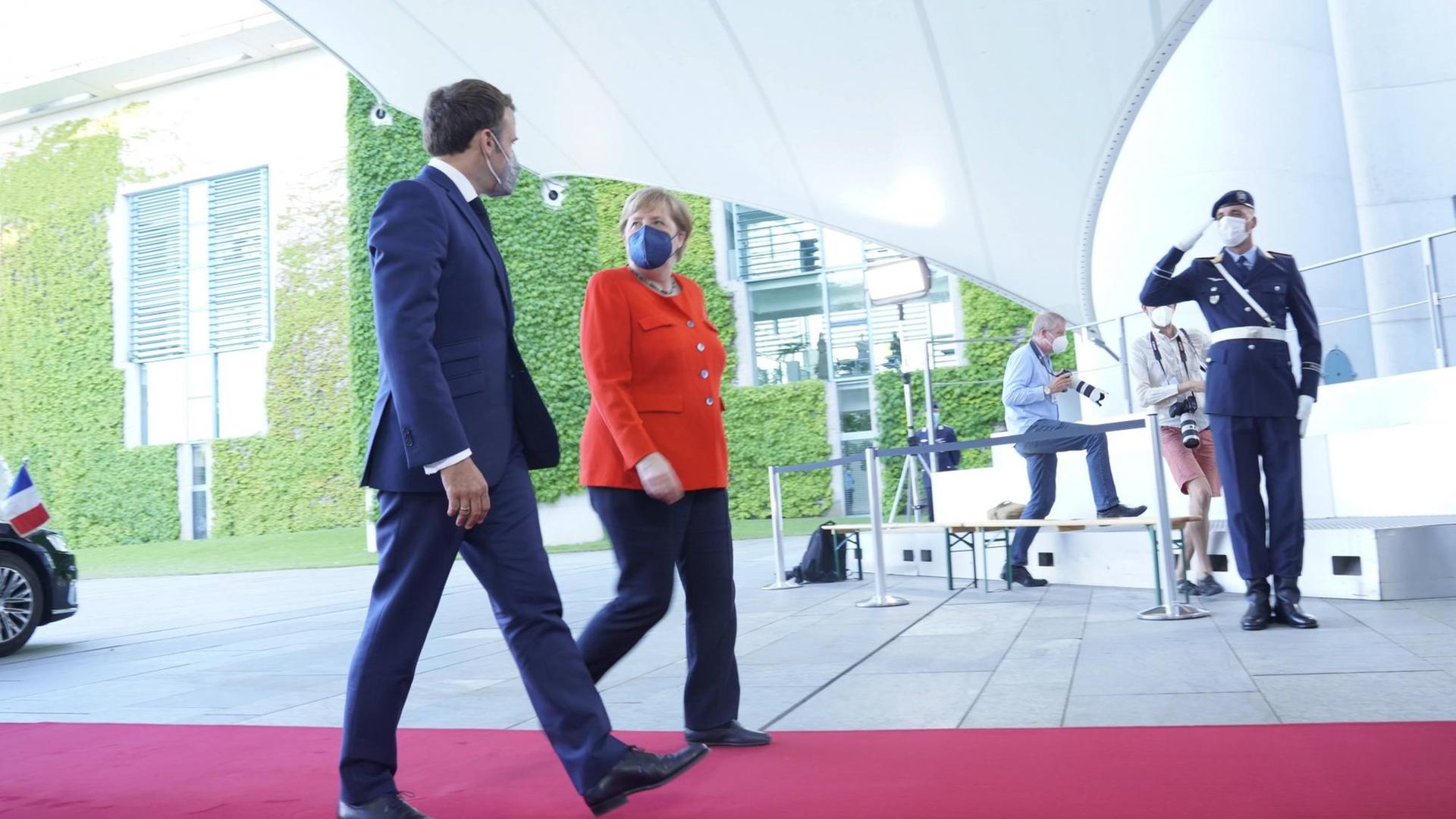 Bundeskanzlerin Dr. Angela Merkel und Emmanuel Macron gehen am 18.06.2021 in Berlin nebeneinander über einen roten Teppich