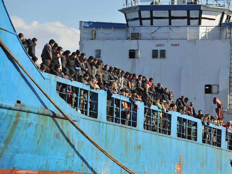 Ein Frachter mit mehreren Hundert Flüchtlingen legt im Hafen der kalabrischen Stadt Crotone an.