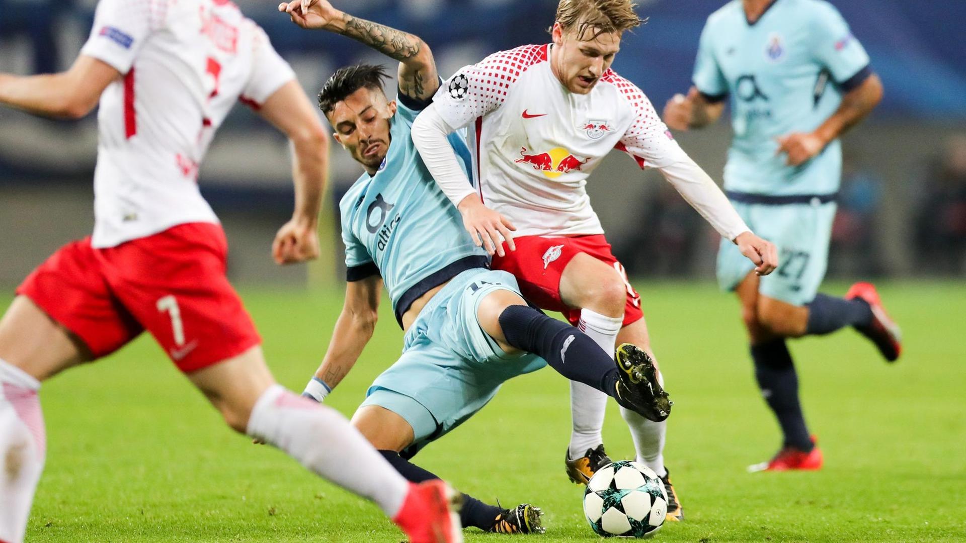 Der Spieler von Leipzig Emil Forsberg kämpft um den Ball mit Alex Telles von Porto im hellblauen Trikot.