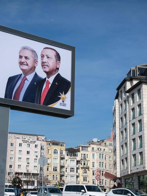 March 11, 2019 - Istanbul, Turkey - On March 8, 2019, an election campaign advertisement featuring Turkish President Recep Tayyip Erdogan and Istanbul mayoral candidate Binali Yildirim hangs over a busy urban street in the Beyoglu district of Istanbul, Turkey.