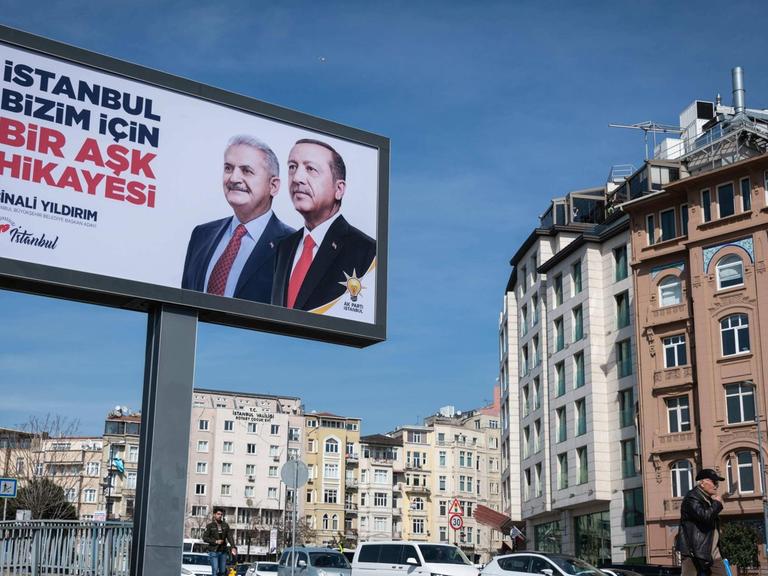 March 11, 2019 - Istanbul, Turkey - On March 8, 2019, an election campaign advertisement featuring Turkish President Recep Tayyip Erdogan and Istanbul mayoral candidate Binali Yildirim hangs over a busy urban street in the Beyoglu district of Istanbul, Turkey.