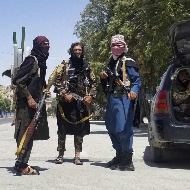 Taliban-Kämpfer posieren schwer bewaffnet vor der Kamera.