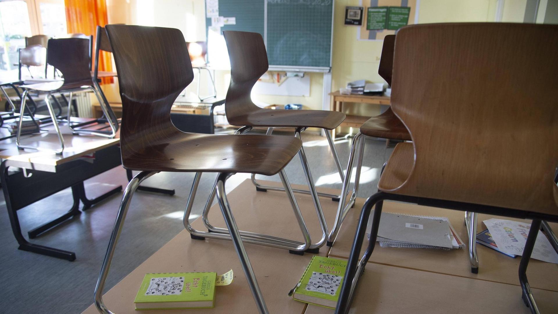 leerer Klassenraum mit hochgestellten Stühlen