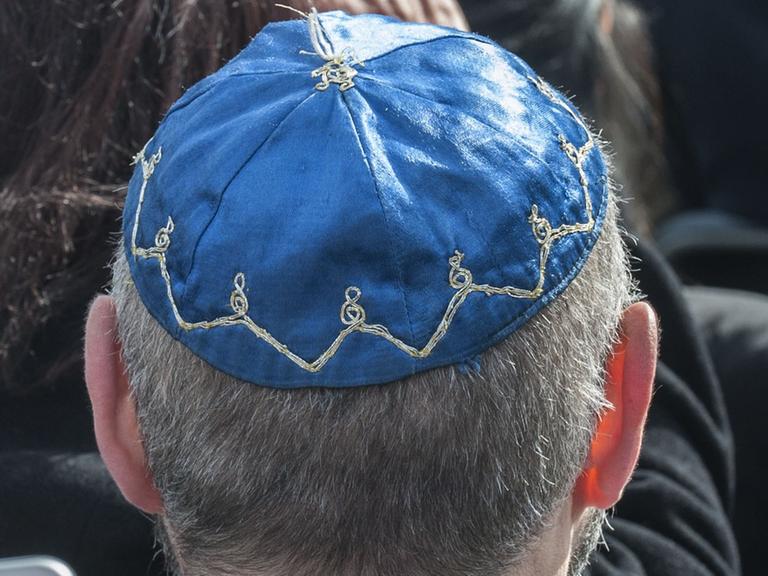 Ein Mann mit der jüdischen Kopfbedeckung Kippa sitzt am 07.05.2015 in Berlin beim Festakt zum zehnten Jahrestag der Übergabe des Denkmals für die ermordeten Juden Europas an die Öffentlichkeit.
