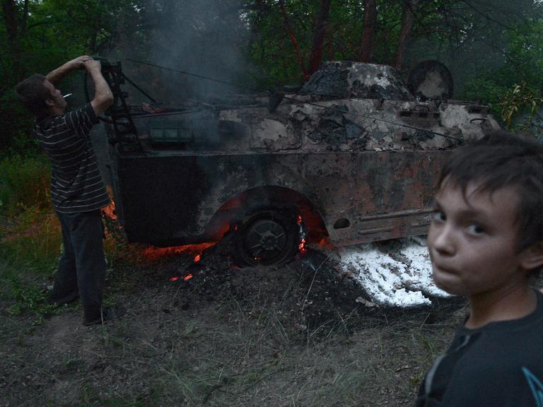 Ein brennendes Fahrzeug im Bezirk Luhansk.