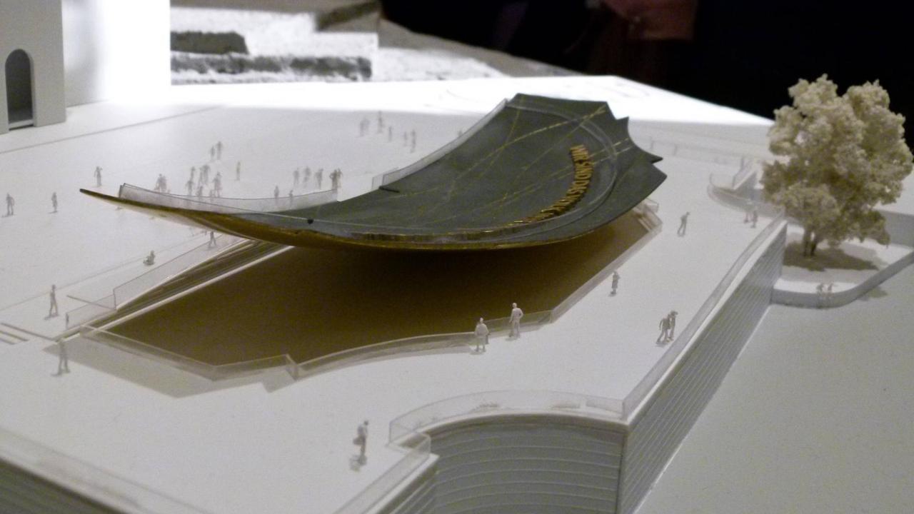 Zu sehen ist ein Modell des geplanten Freiheits- und Einheitsdenkmals. Es zeigt eine gebogene Schale, die einer Wippe ähnelt und von Besuchern begehbar sein soll.