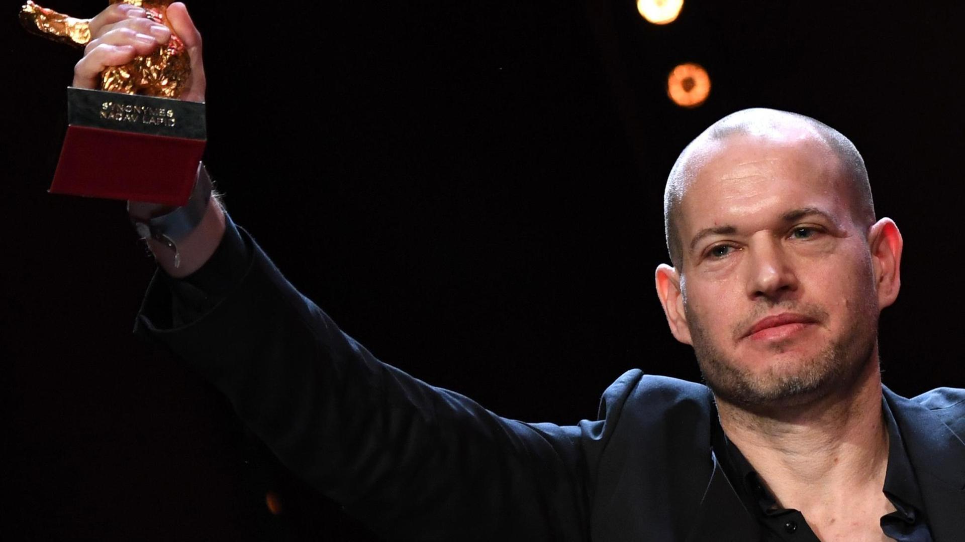 Nadav Lapid, Regisseur des Films "Synonymes" hält den ihm verliehenen Goldenen Bären nach oben. Nadav Lapid, Regisseur des Films "Synonymes" hält den ihm verliehenen Goldenen Bären nach oben.