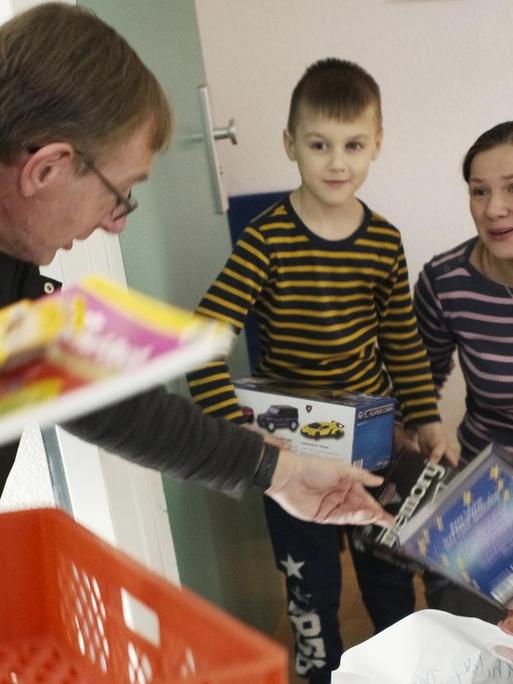 Pastor Bernd Siggelkow (li.) teilt mit während der Corona-Pandemie Buchspenden an bedürftige Familien aus.