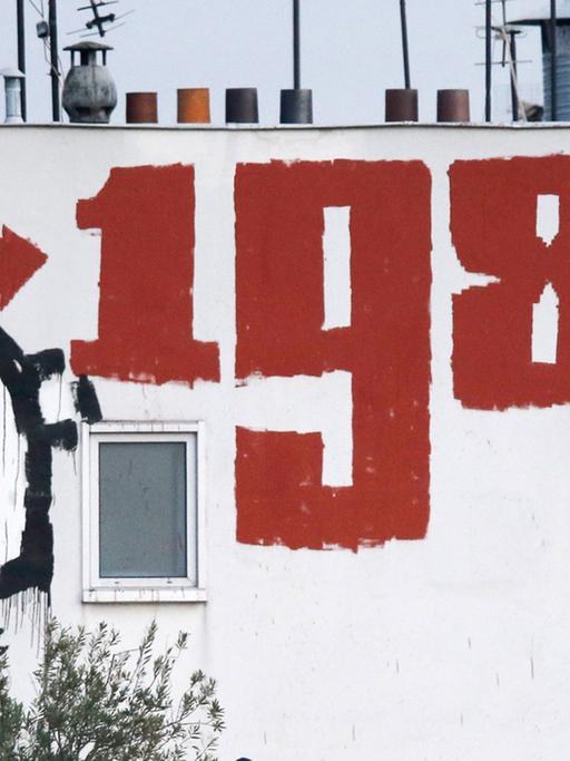 Ein Gebäude am Pariser Place de la Nation mit der Inschrift "1984". Es beziehet sich auf George Orwells Roman "1984" über einen totalitären Überwachungsstaat. Das Buch ist 1949 erschienen.