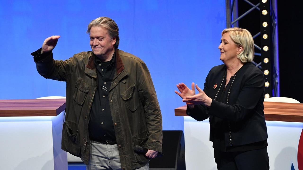 Das Bild zeigt Steve Bannon und die Front-National-Vorsitzende Marine Le Pen auf dem Parteitag in Lille.