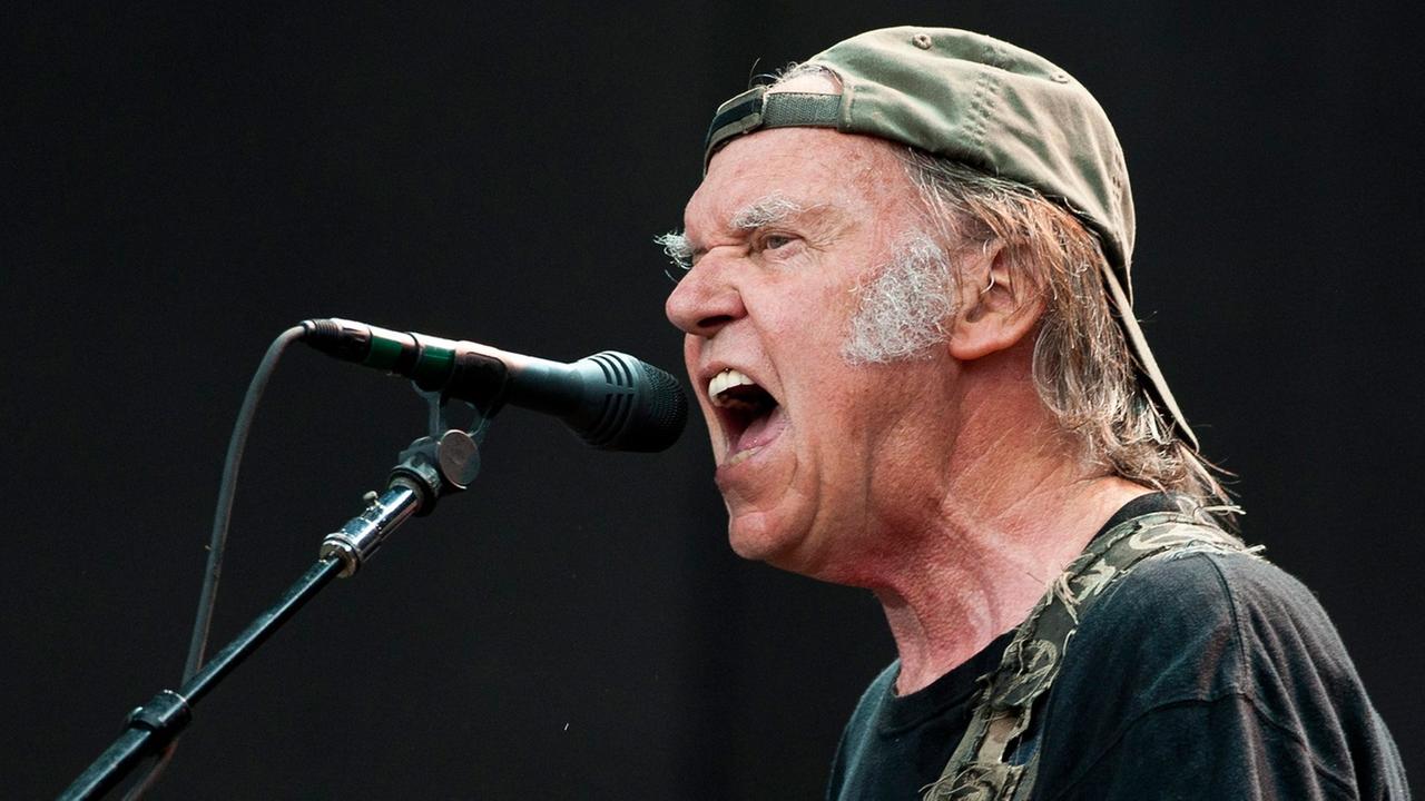Canadian musician Neil Young performs on stage in Hyde Park, central London, England, 12 July 2014. Neil Young performed as the headline act as part of the Barclaycard British Summer Time series of concerts.