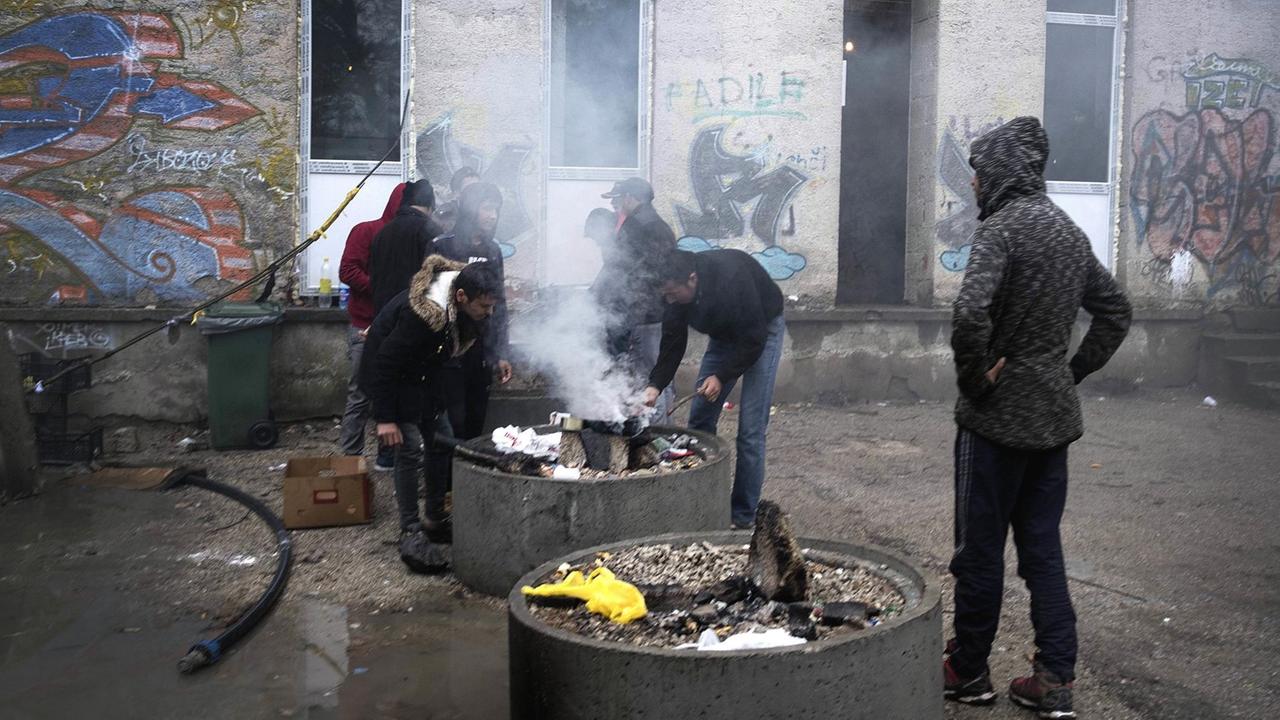 Flüchtlinge in einer Unterkunft der bosnischen Stadt Bihać stehen um eine Feuerstelle herum (November 2018)
