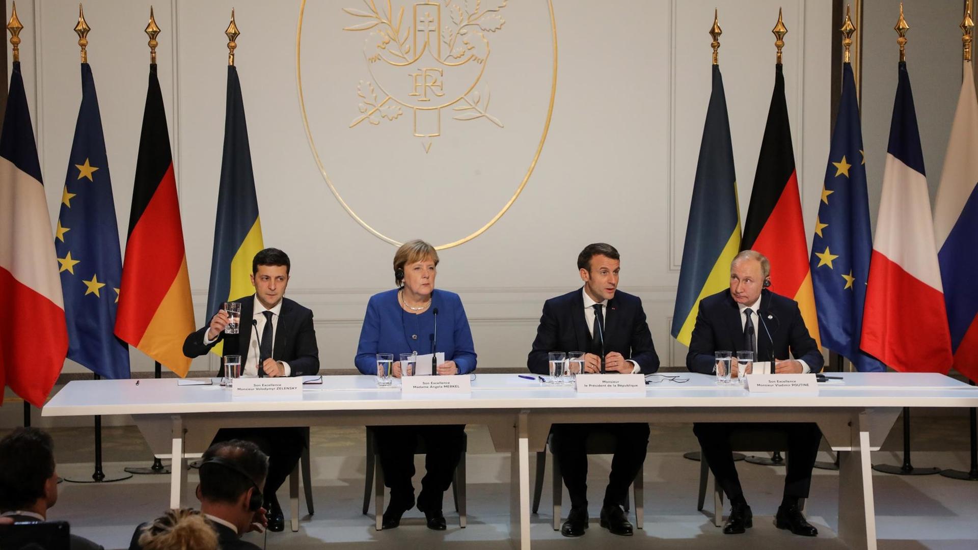 Der ukrainische Präsident Zelensky, Bundeskanzlerin Merkel, Frakreichs Staatschef Macron und der russische Präsident Putin bei einer Pressekonferenz im Elysee Palst