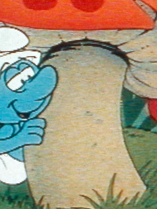 Ein Schlumpf schaut hinter einem Fliegenpilz hervor. Szene aus einer Zeichentrickserie (1981)