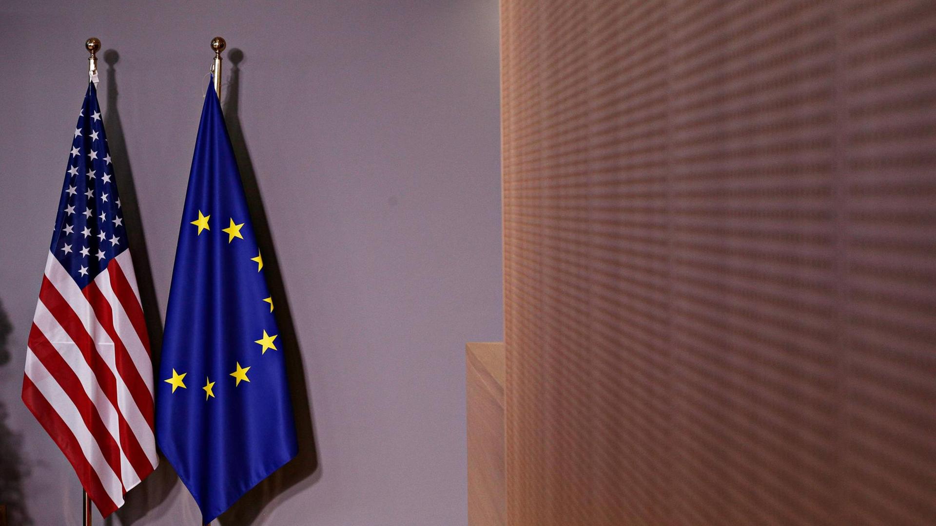 Die Flaggen der EU und der USA stehen vor einem Treffen von US-Präsident Donald Trump und EU-Kommissionspräsident Jean Claude Juncker in einem Raum