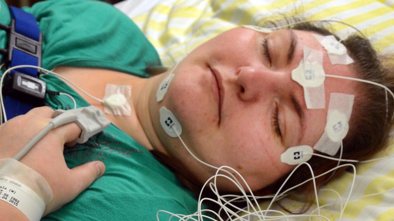 Im Schlaflabor der Robert-Koch-Klinik in Leipzig liegt in der Nacht eine Patientin mit Schlafstörungen nach dem Anlegen von Elektroden in ihrem Bett.