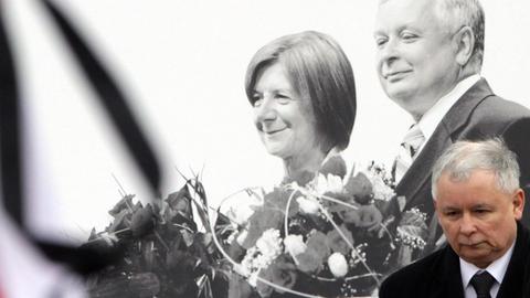 Jaroslaw Kaczynski vor einem Schwarz-Weiß-Bild seines Bruders Lech Kaczynski und dessen Frau